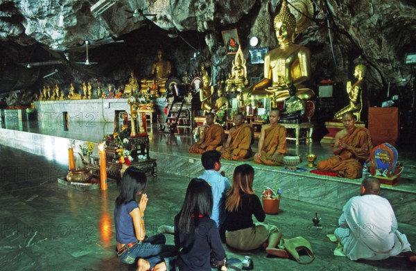 Buddha statue, monks and believers praying, Wat Tam Sua monastery near Krabi, Thailand, December 2002, vintage, retro, old, historic