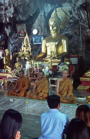 Buddha statue, monks and believers praying, Wat Tam Sua monastery near Krabi, Thailand, December 2002, vintage, retro, old, historic