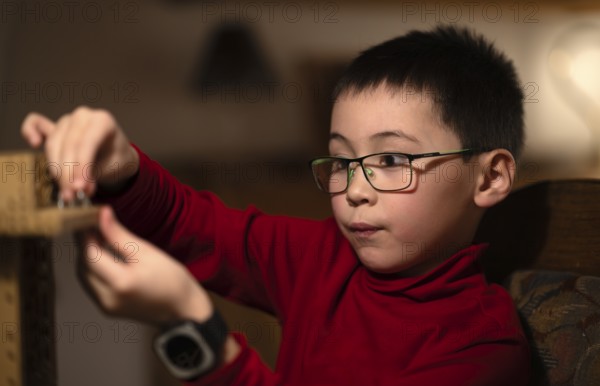 Boy, 6 years, glasses, multi-ethnic, plays concentrated, constructs, builds, Stuttgart, Baden-Württemberg, Germany