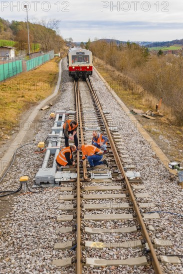 Workers carry out maintenance work on railroad tracks, historic event, first test run with a passenger train on the Hermann tracks, Hesse Railway since 1988, Calw district, Germany