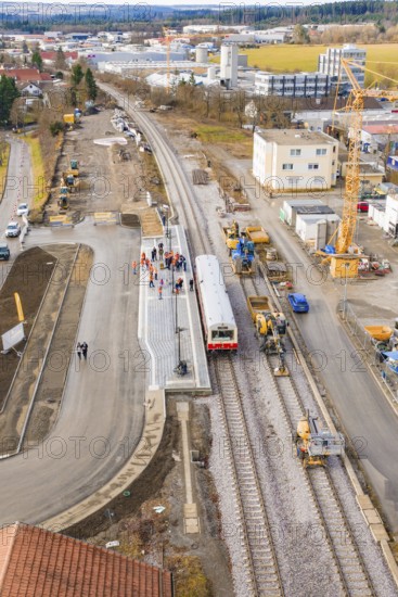 A construction site at a train station with construction work, cranes and a train. Residential buildings can be seen in the background, historic event, first test run with a passenger train on the Hermann tracks, Hesse Railway since 1988, Calw district, Germany