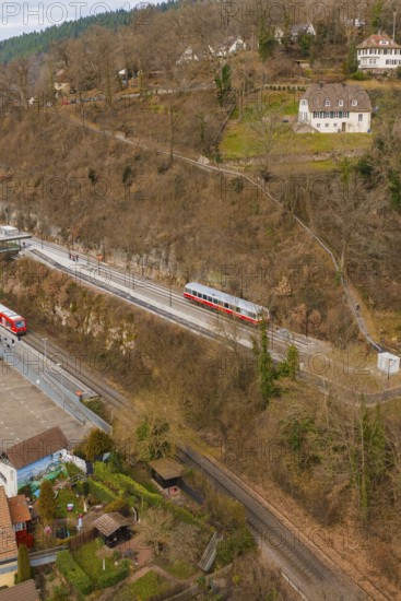 Train travels through hilly terrain with buildings and trees in a winter environment, historic event, first test run with a passenger train on the Hermann tracks, Hesse Railway since 1988, Calw, Calw district, Germany