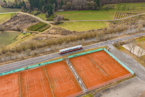 Aerial view of tennis courts next to a train line, historic event, first test run with a passenger train on the Hermann tracks, Hesse Railway since 1988, Ostelsheim, Calw district, Germany