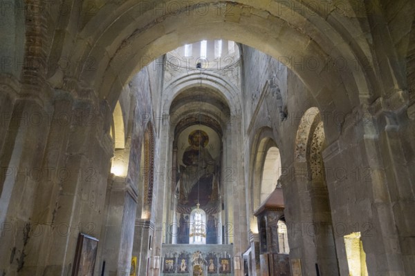 Church interior with high arches and a fresco depicting saints on a background of stone walls, Svetitskhoveli Cathedral, Svetitskhoveli, UNESCO World Heritage Site, Mtskheta, Mtskheta, Mtskheta-Mtianeti region, Georgia