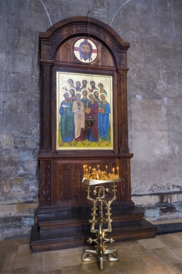A wooden altar with icons of saints and glowing candles in a church, Svetitskhoveli Cathedral, Svetitskhoveli, UNESCO World Heritage Site, Mtskheta, Mtskheta, Mtskheta-Mtianeti region, Georgia