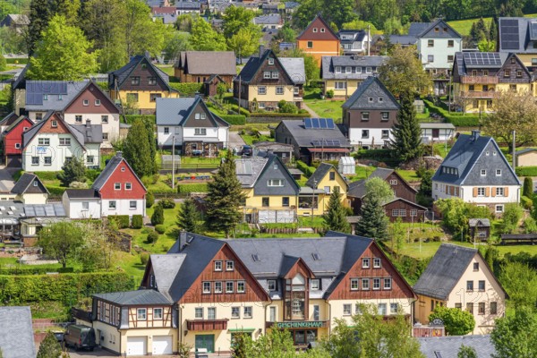 Residential buildings with black roofs and wooden and slate facades, Seiffen health resort and toy village, Ore Mountains, Saxony, Germany