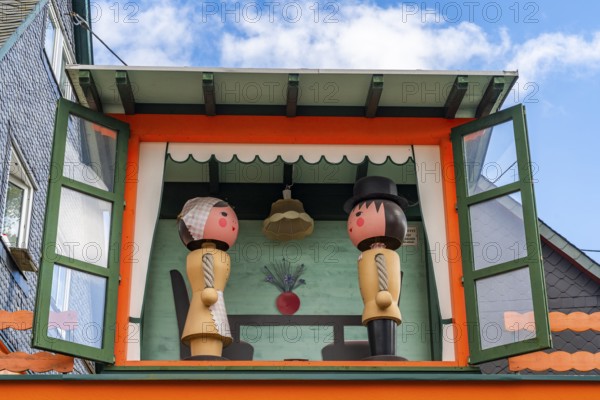Two large wooden figures of man and woman in a small house, health resort and toy village Seiffen, Ore Mountains, Saxony, Germany