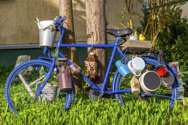 Blue painted bicycle with old pots and jugs, health resort and toy village Seiffen, Ore Mountains, Saxony, Germany