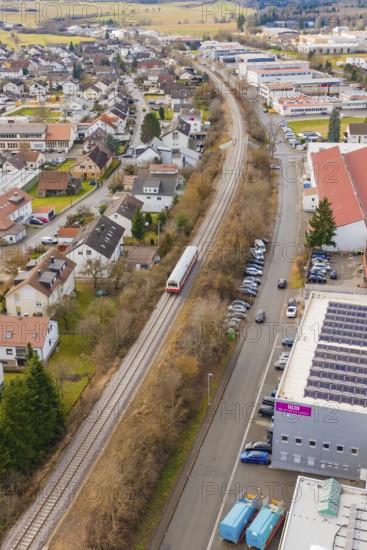 Suburb with a train, surrounded by roads, parked cars and residential buildings in a slightly wooded area, historic event, first test drive with a passenger train on the Hermann tracks, Hesse Railway since 1988, Althengstett, Calw district, Germany
