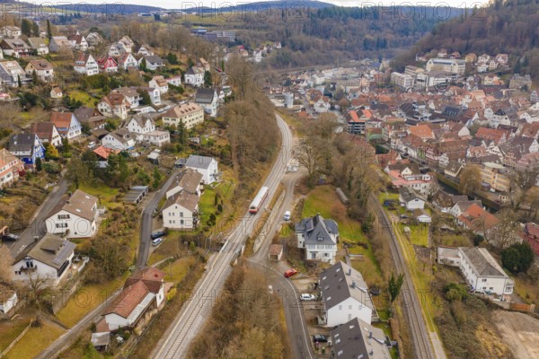 Aerial view of a village with railroad surrounded by hills and autumn trees, historic event, first test run with a passenger train on the Hermann tracks, Hesse Railway since 1988, Calw, Calw district, Germany
