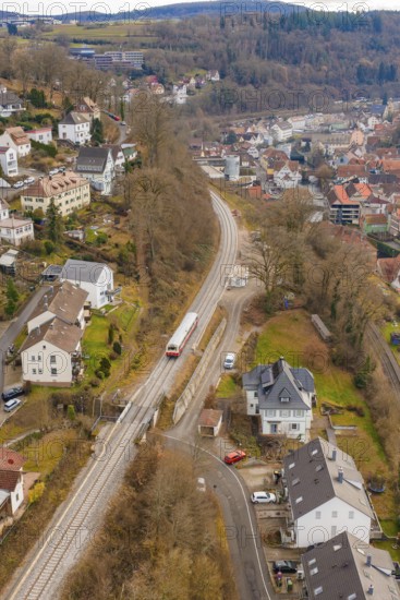 Train through suburban area with nearby houses and a wooded landscape, historic event, first test run with a passenger train on the Hermann tracks, Hesse Railway since 1988, Calw, Calw district, Germany