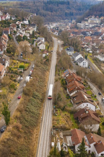 Suburb with railway line through hilly landscape with various residential buildings, historic event, first test run with a passenger train on the Hermann tracks, Hesse Railway since 1988, Calw, Calw district, Germany