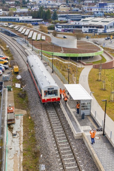 People standing on a platform next to a stopping train in an urban environment, historic event, first test run with a passenger train on the Hermann tracks, Hesse Railway since 1988, Calw, Heumaden, Calw district, Germany