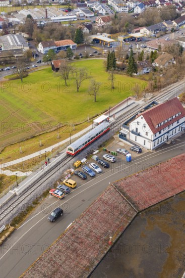 A train at a train station in an urban area with parked cars, historic event, first test run with a passenger train on the Hermann tracks, Hesse railway since 1988, Calw, Heumaden, Calw district, Germany