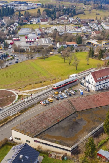 A train stops at a train station in a small town area with residential buildings, historic event, first test run with a passenger train on the Hermann tracks, Hesse railway since 1988, Calw, Heumaden, Calw district, Germany