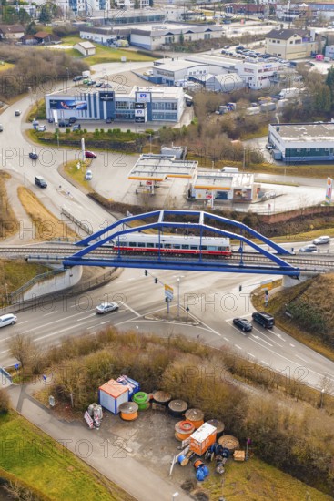 A train crosses a bridge over a roundabout in an urban environment, historic event, first test run with a passenger train on the Hermann tracks, Hesse Railway since 1988, Calw district, Germany