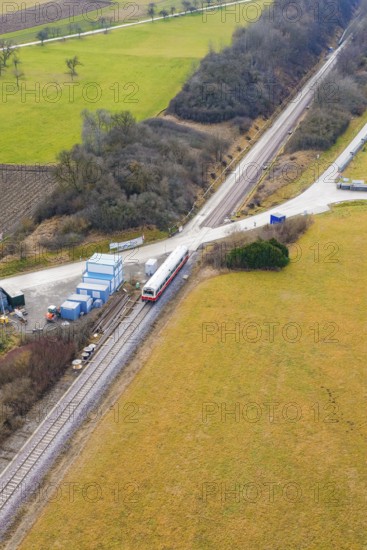 Train at a rural crossroads, surrounded by fields and some trees, northwestern perspective, historic event, first test run with a passenger train on the Hermann tracks, Hesse Railway since 1988, Calw district, Germany