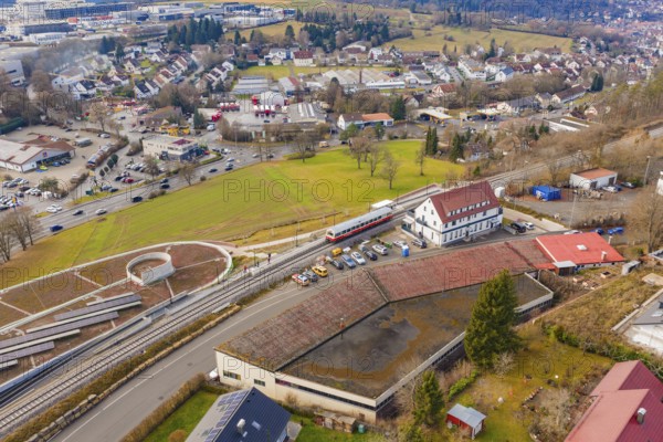 A train at a large train station, surrounded by residential buildings and roads, historic event, first test run with a passenger train on the Hermann tracks, Hesse Railway since 1988, Calw, Heumaden, Calw district, Germany