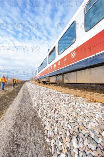Perspective view of a moving train on rails under a blue sky with clouds, historical event, first test run with a passenger train on the Hermann tracks, Hesse Railway since 1988, Calw district, Germany