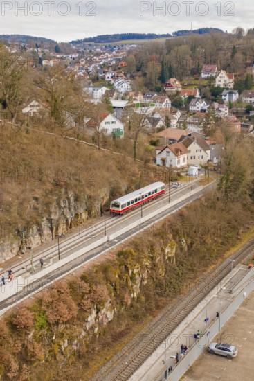 Train waiting at a village station, nestled in hilly rocky landscape in winter, historic event, first test drive with a passenger train on the Hermann tracks, Hesse Railway since 1988, Calw, Calw district, Germany
