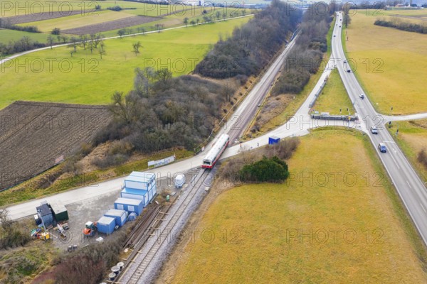 A rural scene with a train on rails, surrounded by fields and roads, historic event, first test run with a passenger train on the Hermann tracks, Hesse Railway since 1988, Calw district, Germany