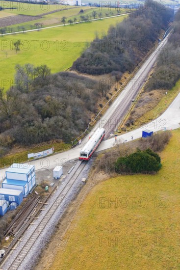 Train travels through a rural landscape with small infrastructures and surrounded by fields, historic event, first test run with a passenger train on the Hermann tracks, Hesse Railway since 1988, Calw district, Germany