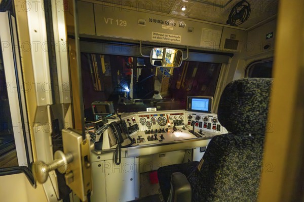 Interior view of a dark train driver's cab at night with illuminated control panel and technical displays, historic event, first test run with a passenger train on the Hermann tracks, Hesse Railway since 1988, Calw district, Germany