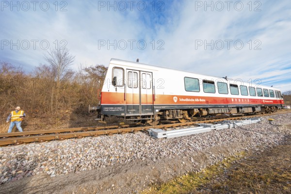 A train with a worker standing on rails next to it, with a landscape of trees in the background, historic event, first test run with a passenger train on the Hermann tracks, Hesse Railway since 1988, Calw district, Germany