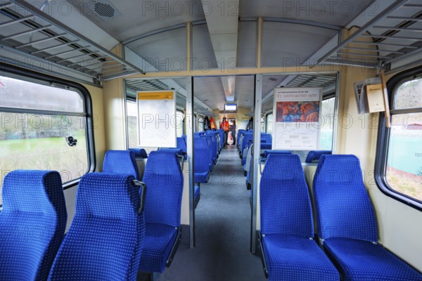 Neatly arranged blue seats inside a train with lots of daylight, historic event, first test run with a passenger train on the Hermann tracks, Hesse Railway since 1988, Calw district, Germany
