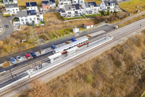 Small train stops at a railway stop within a residential development, historic event, first test run with a passenger train on the Hermann tracks, Hesse Railway since 1988, Ostelsheim, Calw district, Germany