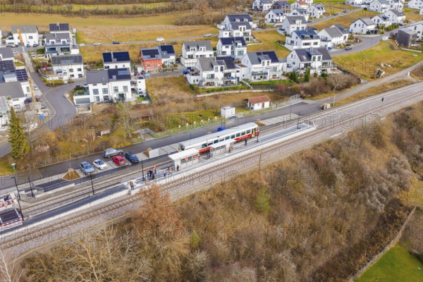 New residential development next to railway tracks in winter surroundings, historic event, first test run with a passenger train on the Hermann tracks, Hesse Railway since 1988, Ostelsheim, Calw district, Germany