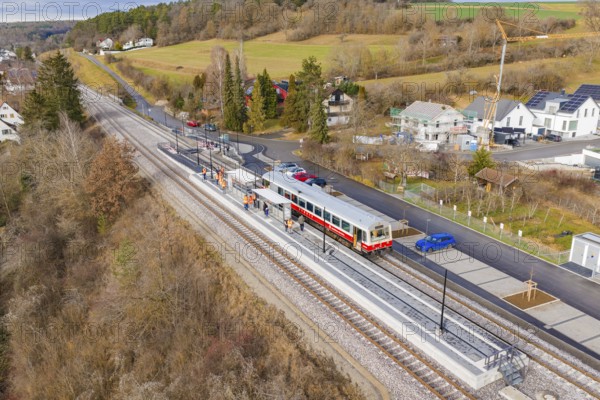Small train on the platform in a rural area with houses and trees, historic event, first test run with a passenger train on the Hermann tracks, Hesse Railway since 1988, Ostelsheim, Calw district, Germany