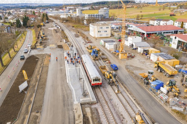 A construction site for a new station with a train, surrounded by construction and cranes, historic event, first test run with a passenger train on the Hermann tracks, Hesse Railway since 1988, Althengstett, Calw district, Germany