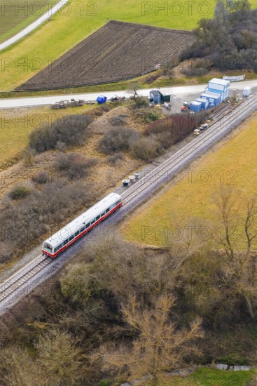 A train travels through a rural area along the railway tracks, surrounded by trees and fields, historic event, first test run with a passenger train on the Hermann tracks, Hesse Railway since 1988, Calw district, Germany