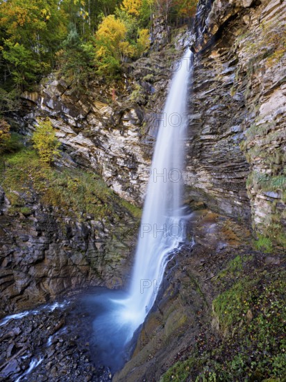 Diesbach waterfall in autumn-colored surroundings, Linthal, Klausenpass, Canton of Glarus, Switzerland