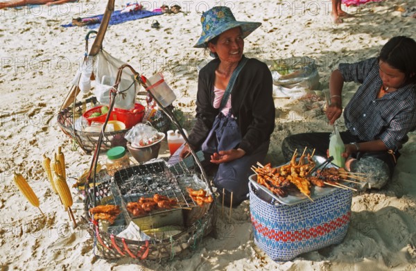 Woman and daughter with food stash on Pranang Cave beach, two years in front of the tsunami, Krabi, Thailand, December 2002, vintage, retro, old, historic