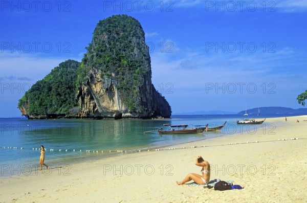 Rocks in the sea, people and longtail boats on Pranang Cave beach, two years in front of the tsunami, Krabi, Thailand, December 2002, vintage, retro, old, historic