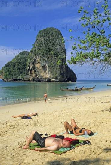 Rocks in the sea, people and longtail boats on Pranang Cave beach, two years in front of the tsunami, Krabi, Thailand, December 2002, vintage, retro, old, historic