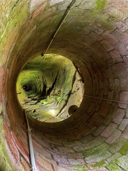 View down into well shaft from 176 meters deep deepest castle well in the world Fountain of medieval imperial castle Kyffhausen next to Barbarossa monument, Kyffhäuser nature park Park, Thuringia, Germany