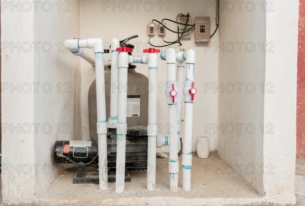 Pool pump with sand filter installed. Pool purification and maintenance system. Home pool filter and treatment plant installed