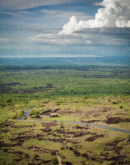 Aerial view of an asphalt road in a rural location. Landscape of a rural road surrounded by vegetation. View of an asphalt road in a green and natural place