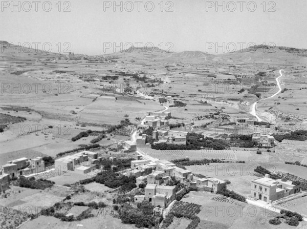 View from citadel in Victoria over countryside looking towards Ghasri and Giordan lighthouse in distance, Island of Gozo, Malta, Europe 1956