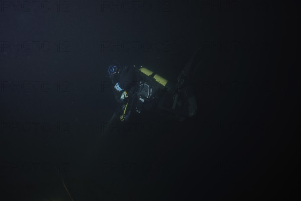 Divers at night in Lake Walen. Tauchplatz Känzeli, Mols, Canton of St. Gallen, Switzerland