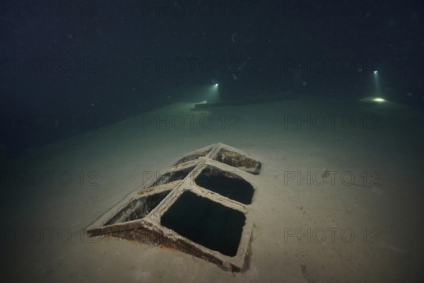 Divers examine a ledi wreck, wreck of a ledi ship, Ledi ship, cargo ship for mass freight, bulk cargo, at night in Lake Walen. Tauchplatz Känzeli, Mols, Canton of St. Gallen, Switzerland