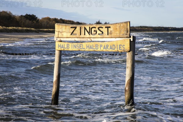 Wooden poles in the sea with wooden sign Zingst Half Island Half Paradise, Zingst, Fischland-Darß-Zingst, Western Pomerania Lagoon Area National Park, Mecklenburg-Western Pomerania, Germany