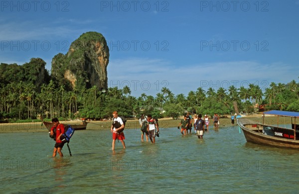 Tourists wade to their boat taxi that brings them back to Krabi, two years in front of the tsunami, Railay East, Krabi, Thailand, December 2002, vintage, retro, old, historic