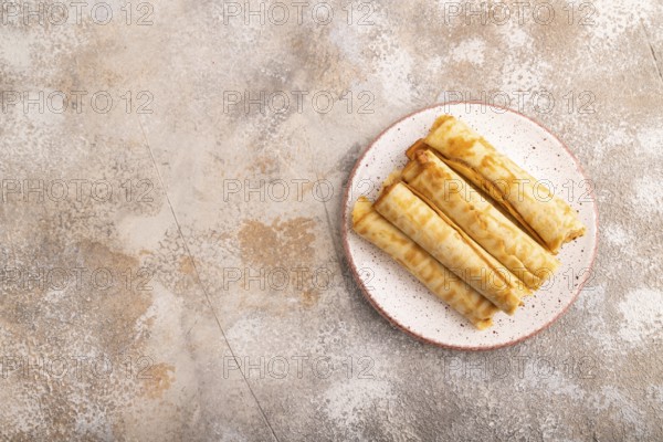 Waffles with caramel on brown concrete background, top view, flat lay, copy space