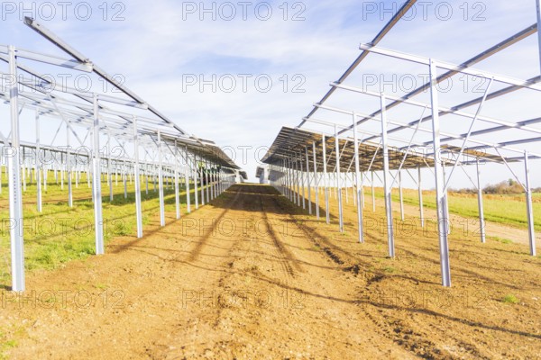 Metal frameworks for solar panels in a field under a blue sky, Energiewende, construction of PV open space, Baden-Württemberg, Germany