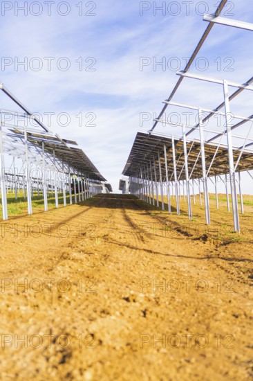Straight rows of metal structures under blue sky, Energiewende, construction of PV open space, Baden-Württemberg, Germany