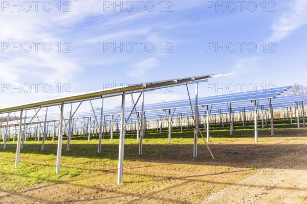 Construction of solar plant series under blue skies, Energiewende, construction of PV open space, Baden-Württemberg, Germany